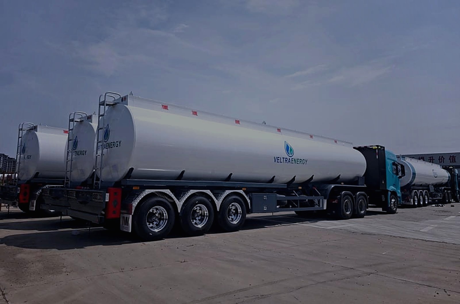 New Veltra Energy fuel tankers lined up, side view